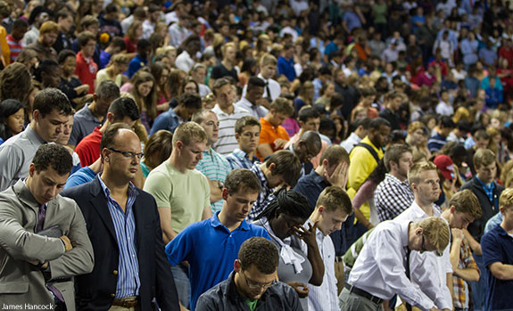 Liberty University students pray during a moment of silence in remembrance of 9/11.