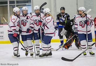 DI women's hockey team celebrates goal at the LaHaye Ice Center.