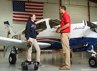 Liberty aeronautics students with a Piper aircraft.