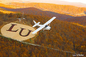 A Cessna Skyhawk flys over Liberty University's mountain property.