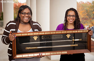 Liberty University debaters Vida Chiri and Meagan Edwards with the coveted USMA tournament sword.