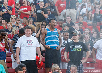 Students get drenched by a fire hose.