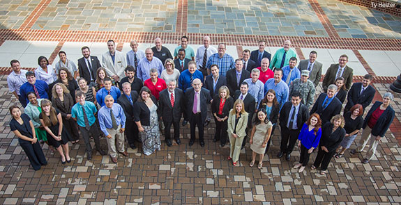 New Liberty University faculty members with the university's provost and vice provost.
