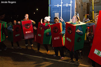 Liberty University students dressed as Operation Christmas Child shoeboxes dance outside the collection truck