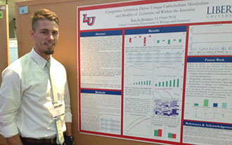 Liberty University senior Ryan Montalvo with his award-winning poster.