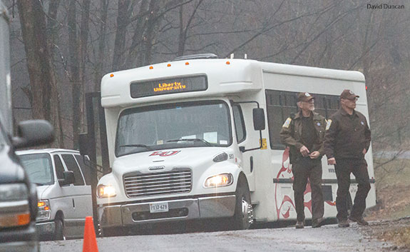 Two Bedford County Sheriffs investigate a cold case crime scene near a Liberty bus.