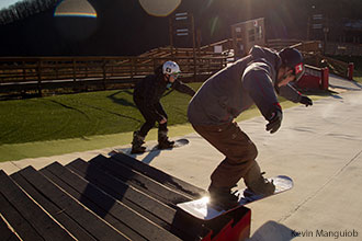 Snowboarders slide down the stairs at Liberty Mountain Snowflex Centre.