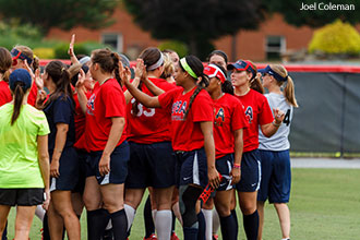 Prospective USA Softball National Team members huddle at the Liberty Softball Field.