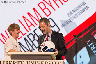 William Byron presents a racing helmet to Liberty University President Jerry Falwell