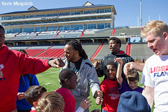 Mike Brown coaches kids at the Skills and Drills Mini-Camp at Williams Stadium.