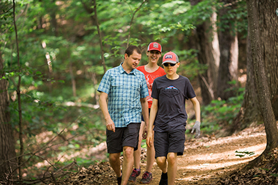 Dr. Clark Zealand, an associate dean at Liberty, joins his wife, Andrea, and son, Coleman, on the Liberty Mountain Trail System on Thursday afternoon. (Photo by Kevin Manguiob)