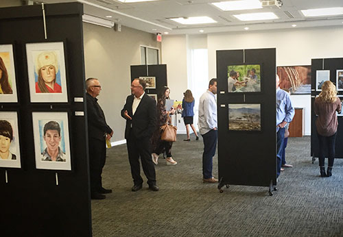 Vernon Brewer (left), president of World Help, meets with Todd Smith, Liberty's SADA chair, at a student art exhibition during Global Focus Week. (Photo courtesy of Chelsea Bevins)