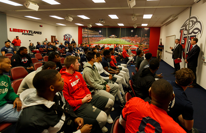 Flames Football players meet with Falwell, Gill, and McCaw after the news conference.