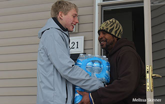 A Liberty student delivers water in Flint, Mich.