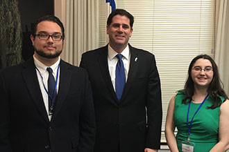 Ambassador Ron Dermer welcomes two Liberty University students to his office.