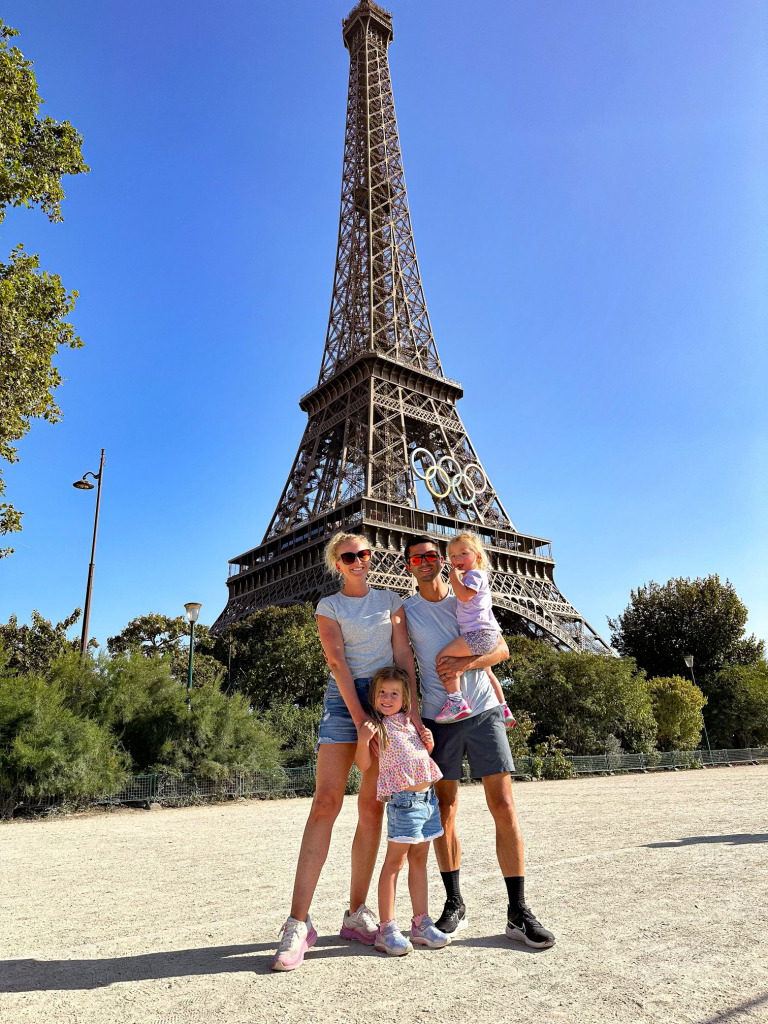 Kristina and Parker Spencer with their daughters in front of the Eiffel Tower