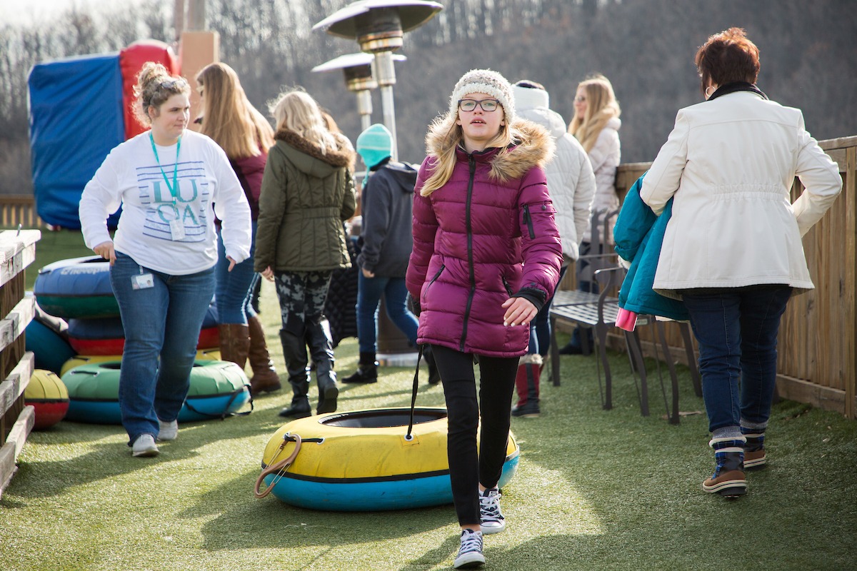 Young girl pulling a tube at Snowflex during the LUOA Christmas Party
