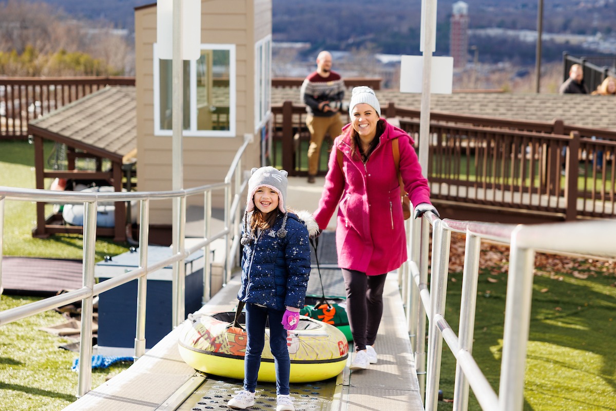 Mom and daughter on the Snowflex tubing slope during the LUOA Christmas Party