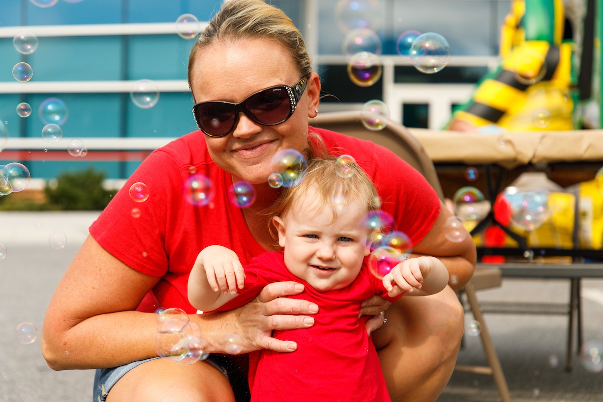 Families participating in activities at the LUOA tailgate