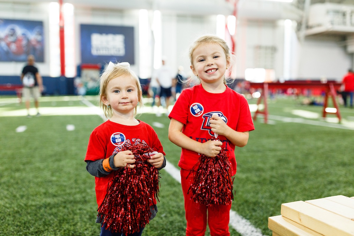 Families participating in activities at the LUOA tailgate