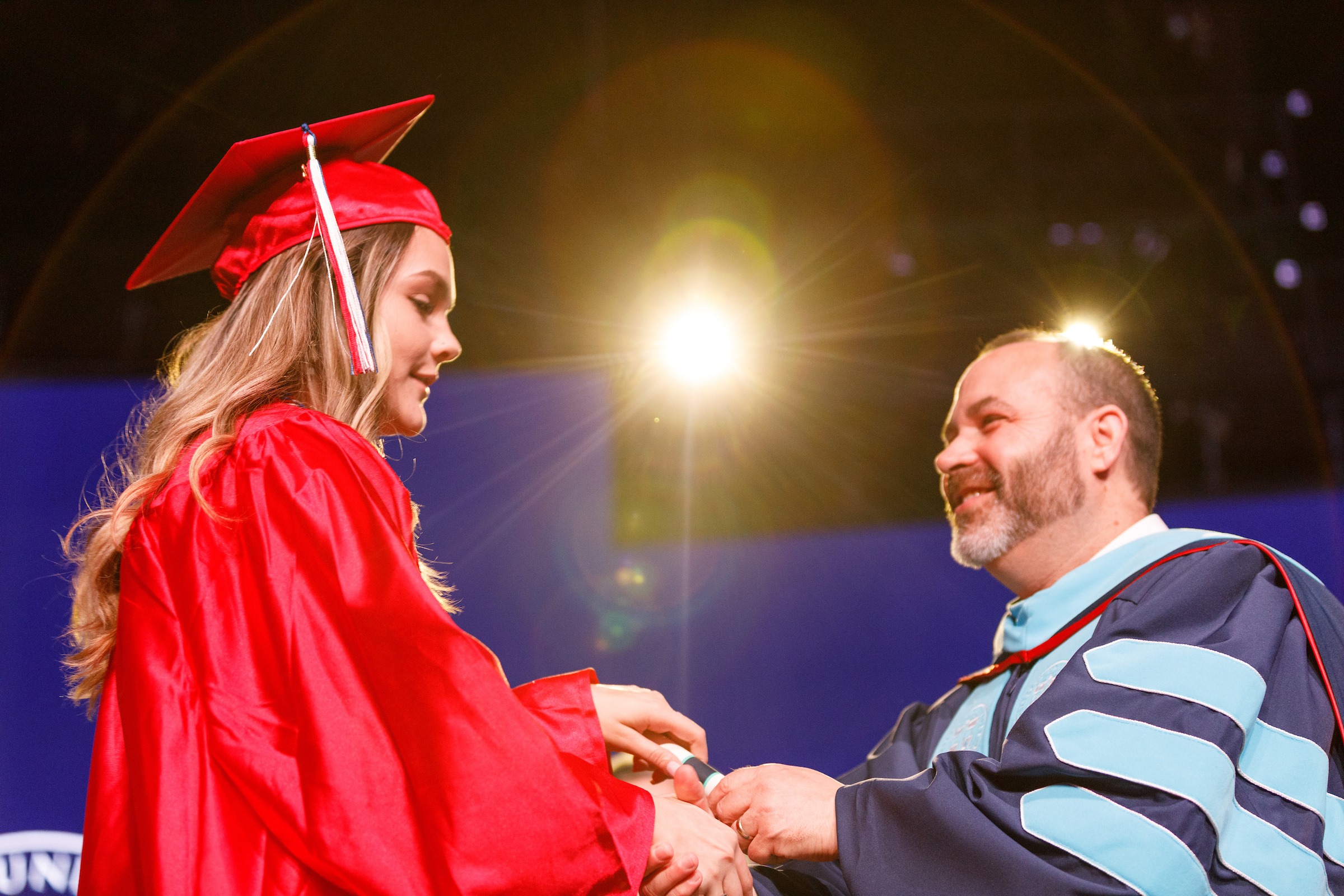 Female LUOA graduate receiving her diploma