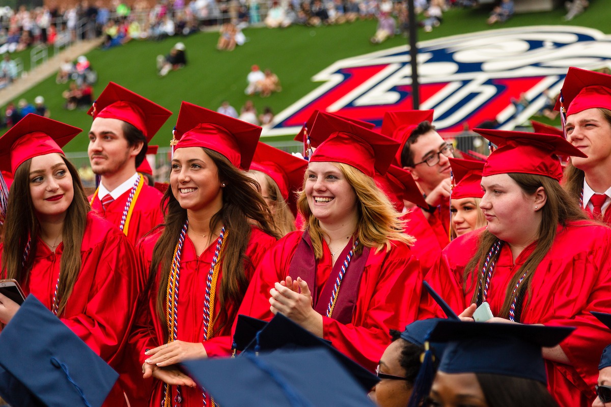 LUOA graduates smiling during commencement ceremony