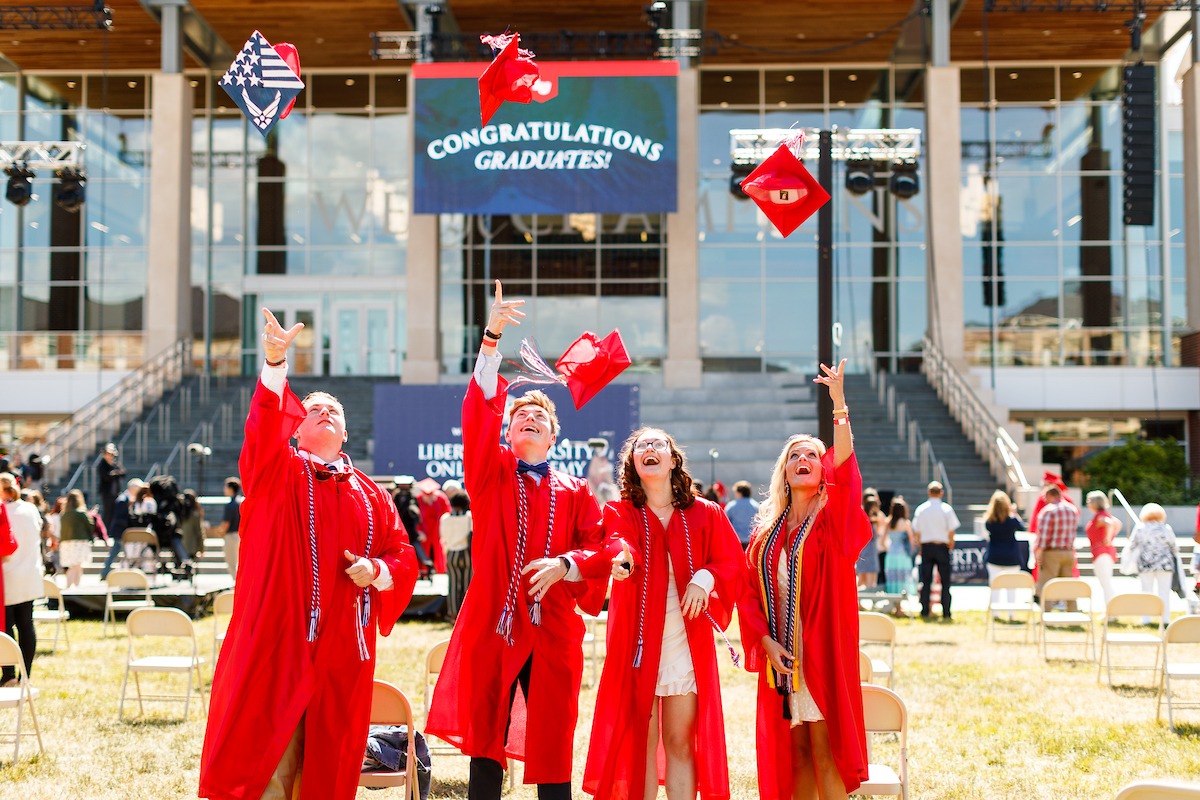 LUOA graduates throwing their caps