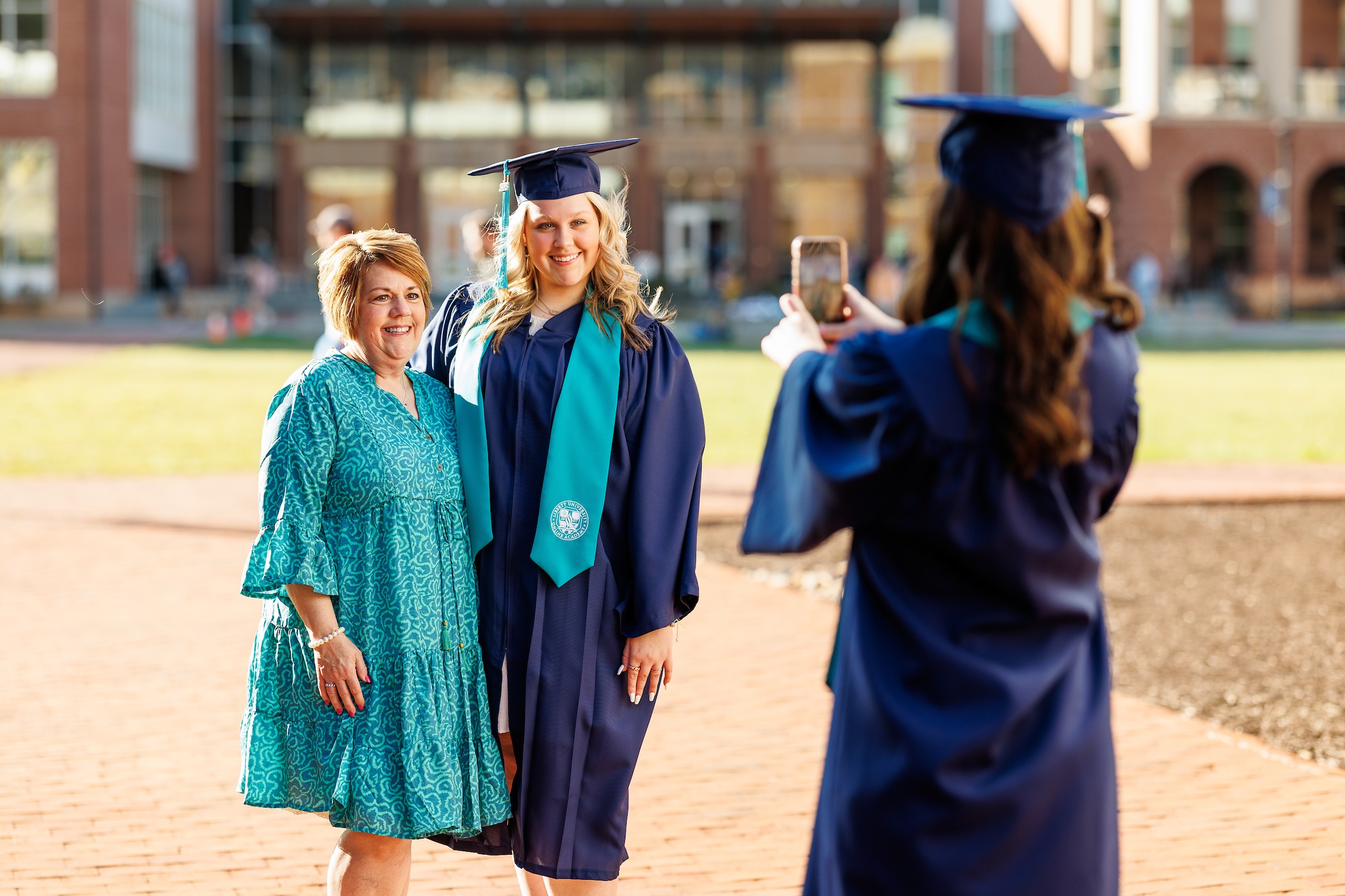LUOA High School Graduate in regalia and her mother