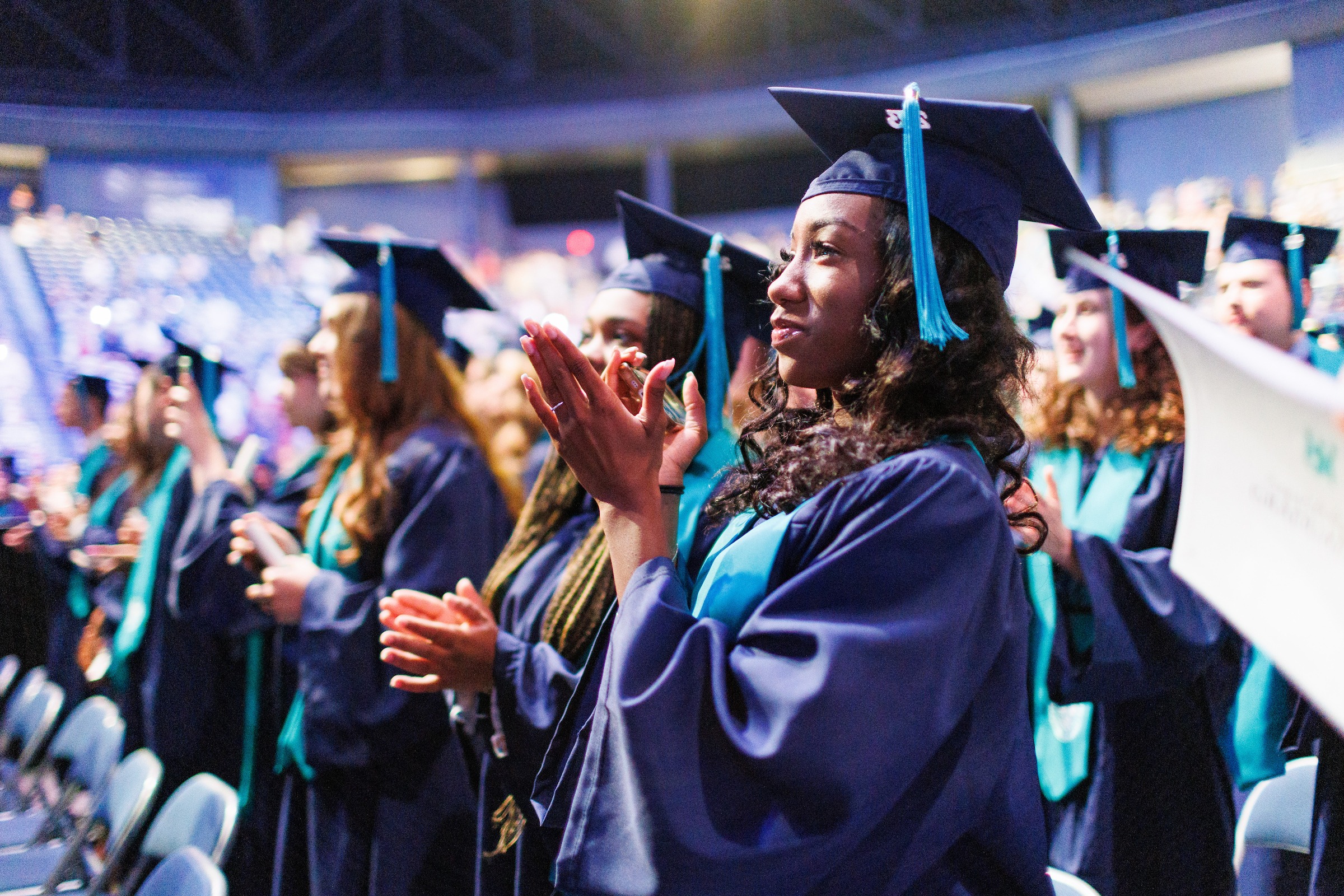 Group of LUOA students clapping during the commencement ceremony