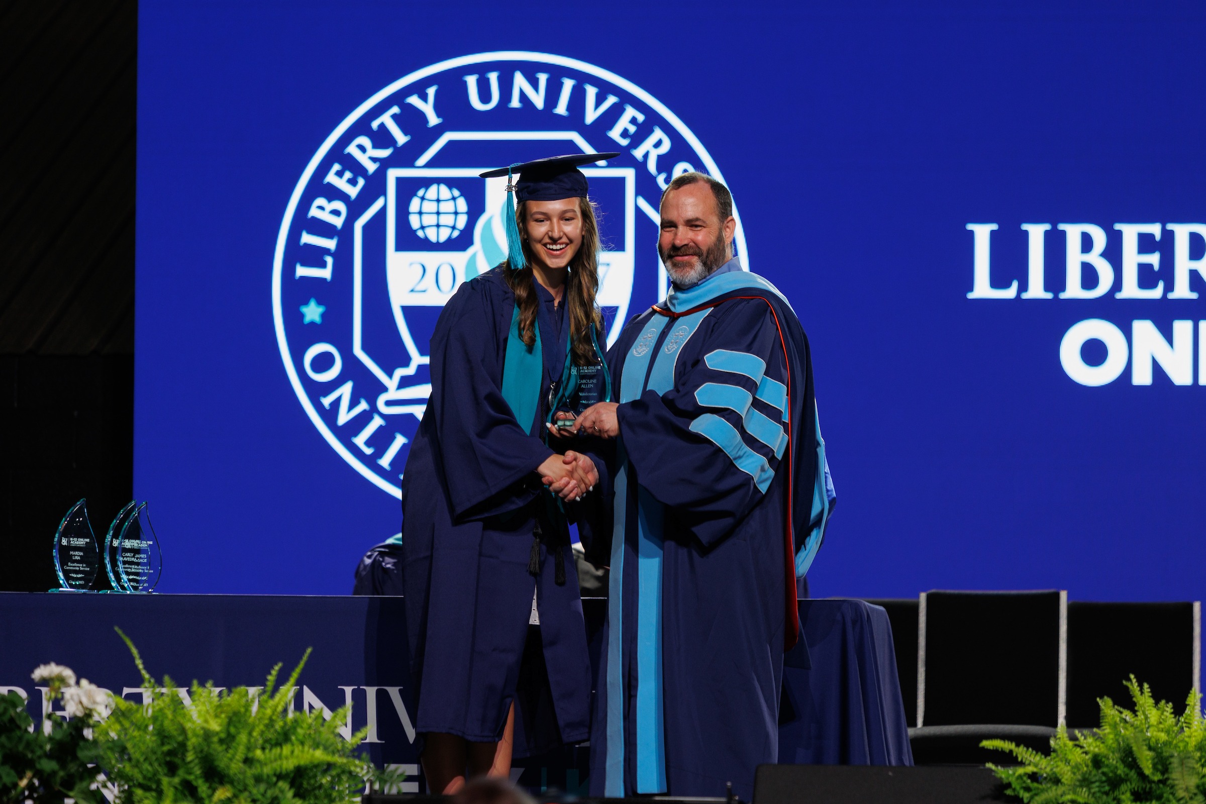 Female LUOA student receiving an award on stage