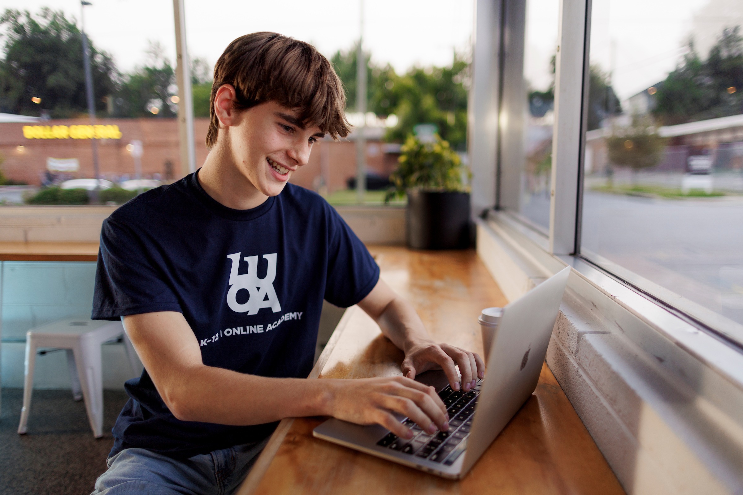 Male LUOA student working on his laptop