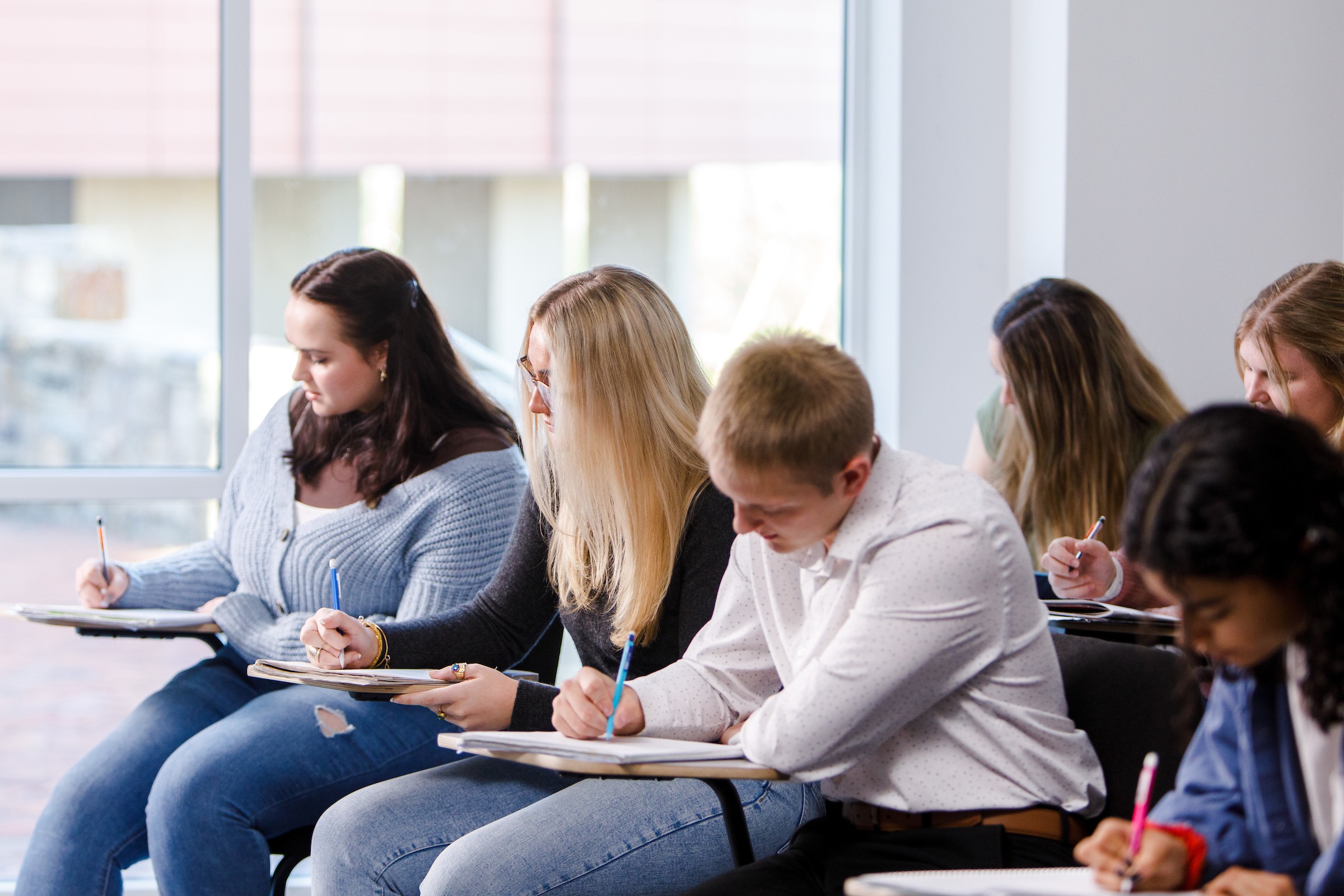Students in a classroom taking an exam