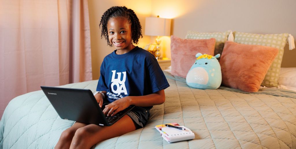 Young female LUOA student studying at home