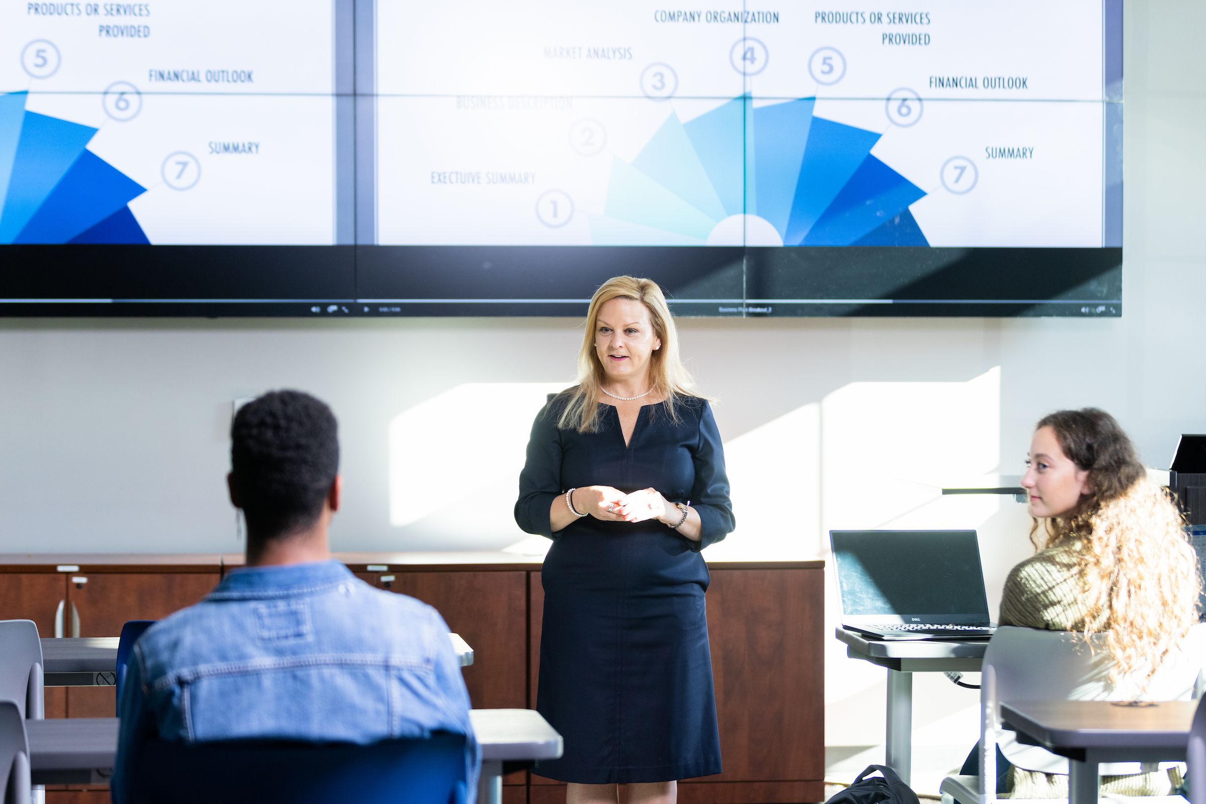 Female business leader giving a presentation in front of a class