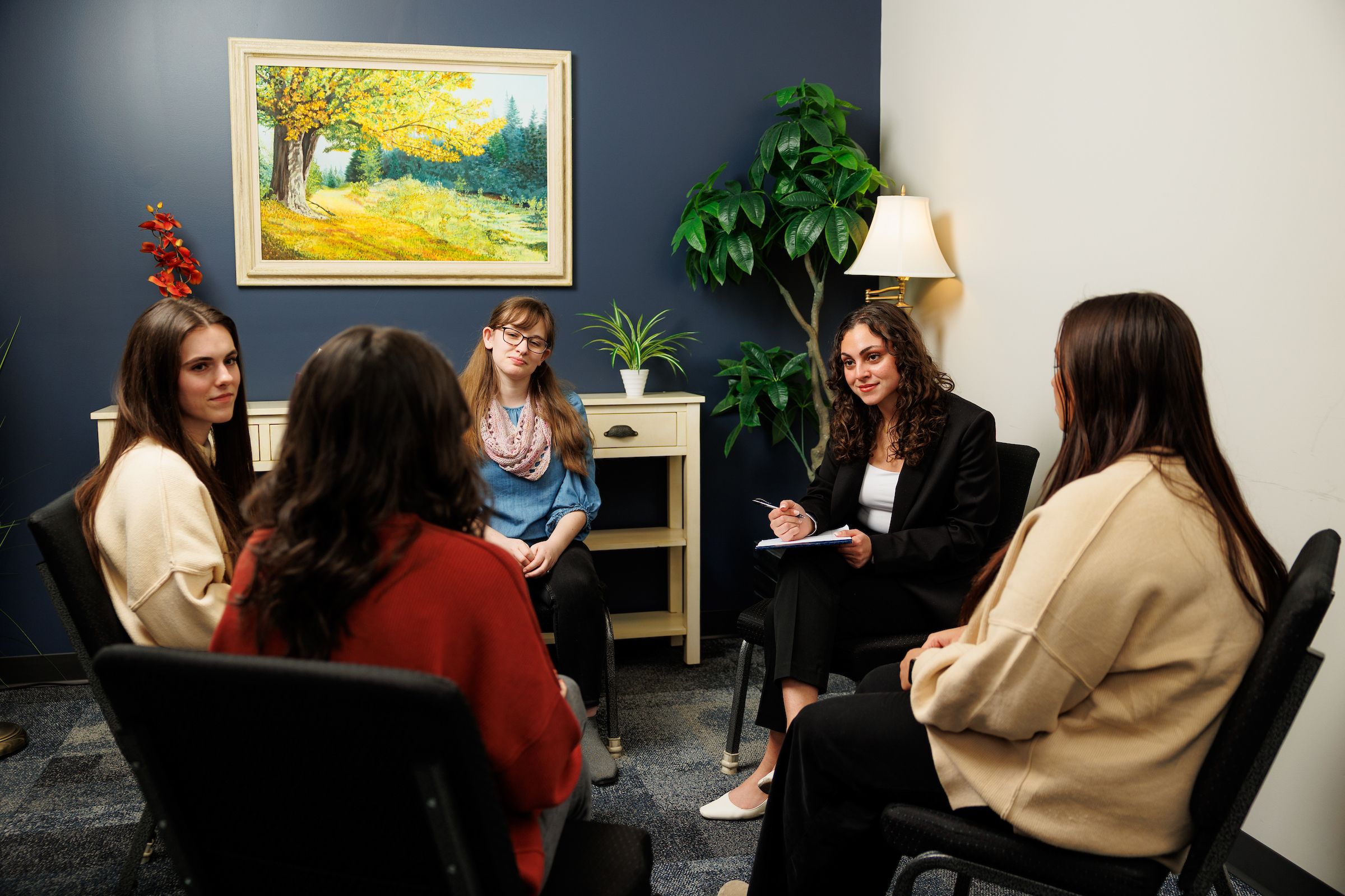 Female counseling leader talking to a small group