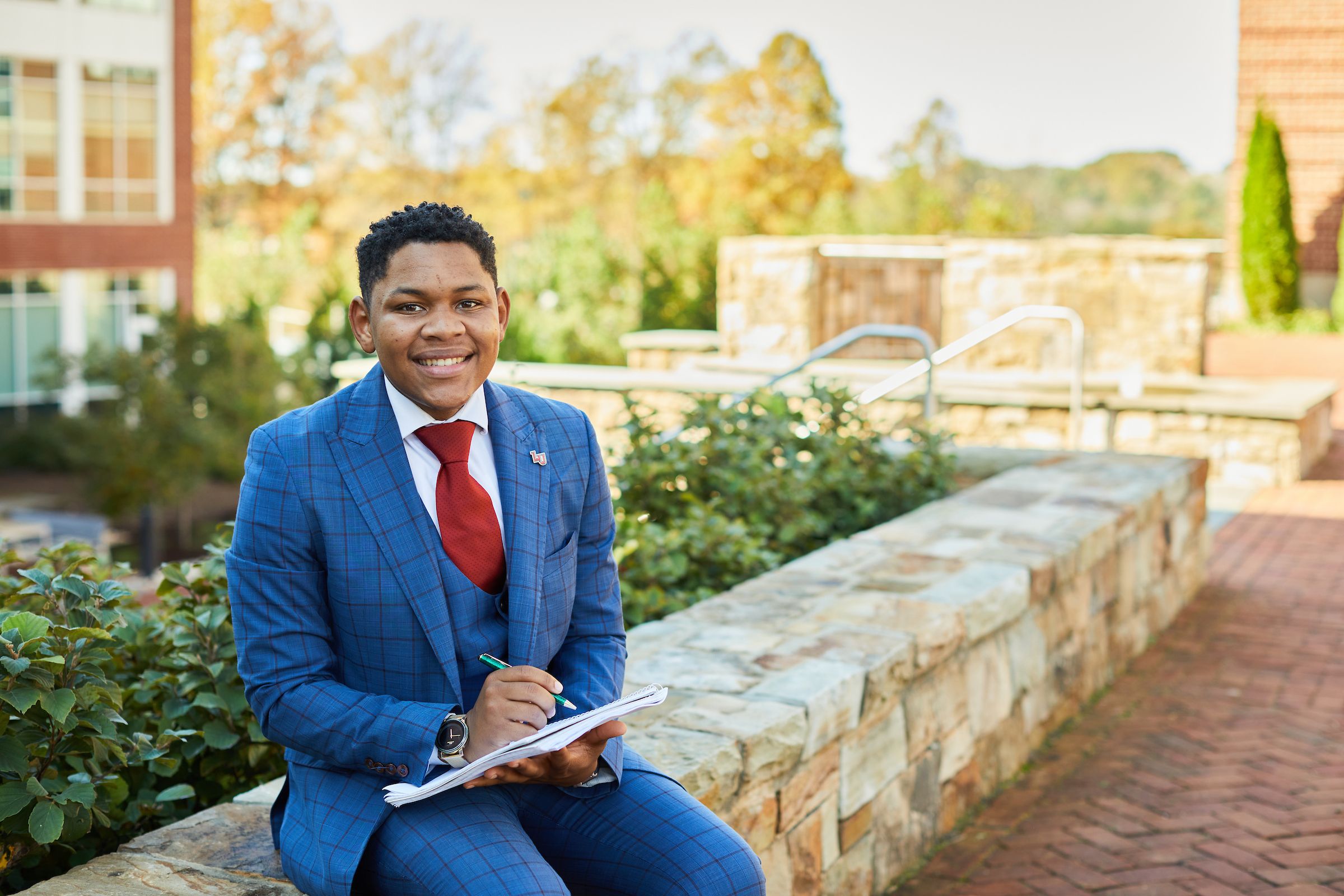 Government leader seated outside smiling at the camera