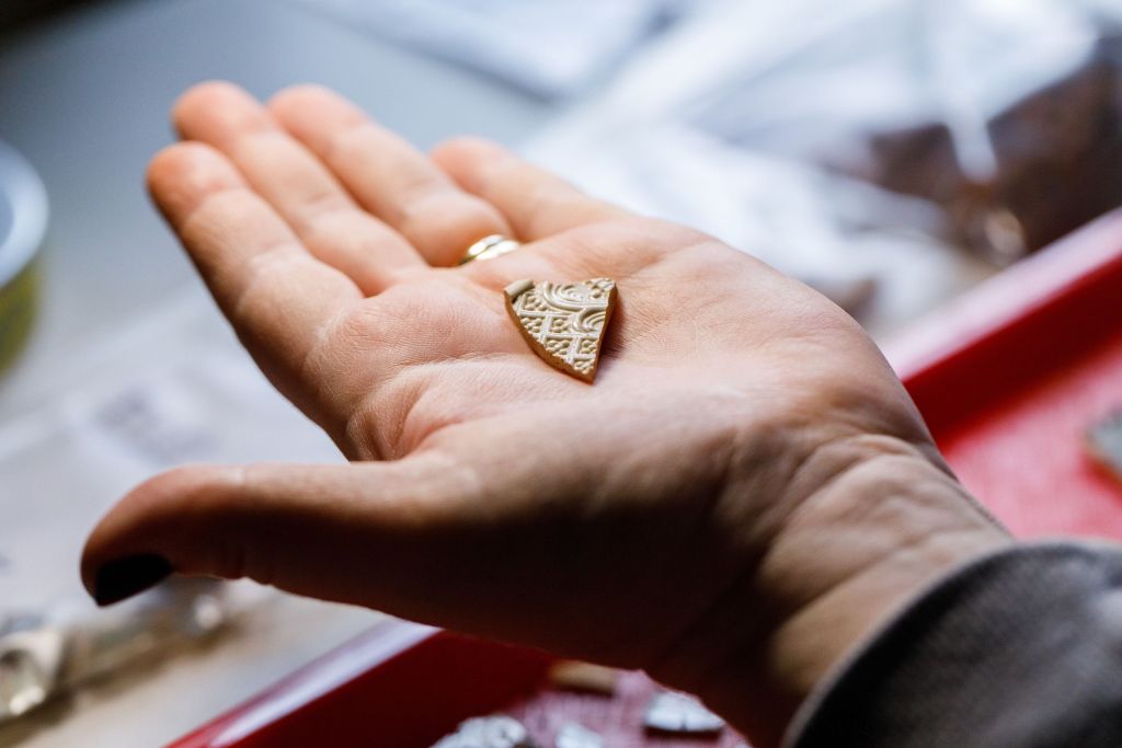 Liberty University graduate history program student holding a piece of pottery