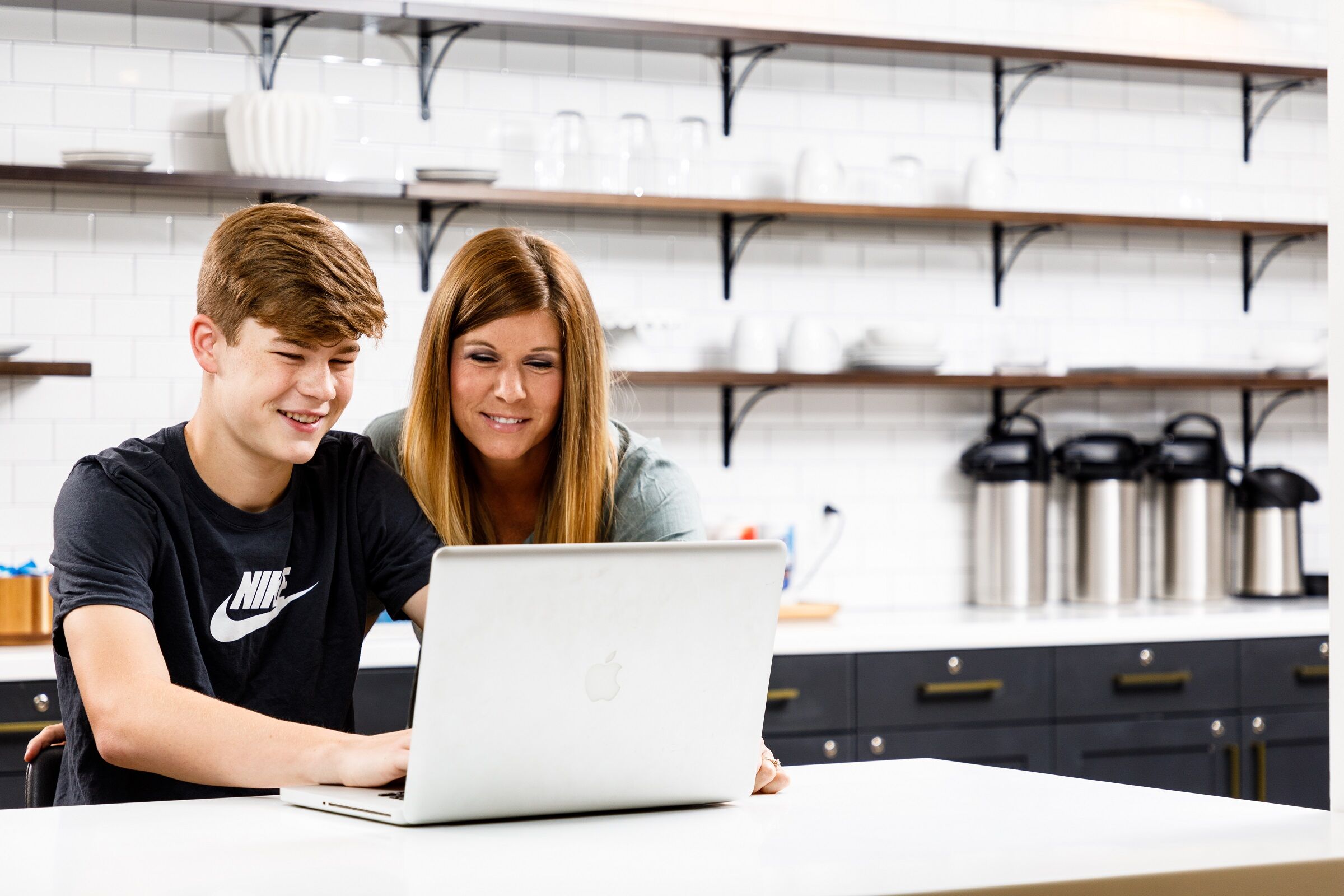 A parent and their student looking at Ember curriculum