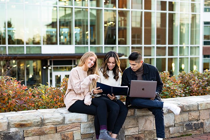 Students sitting outside talking