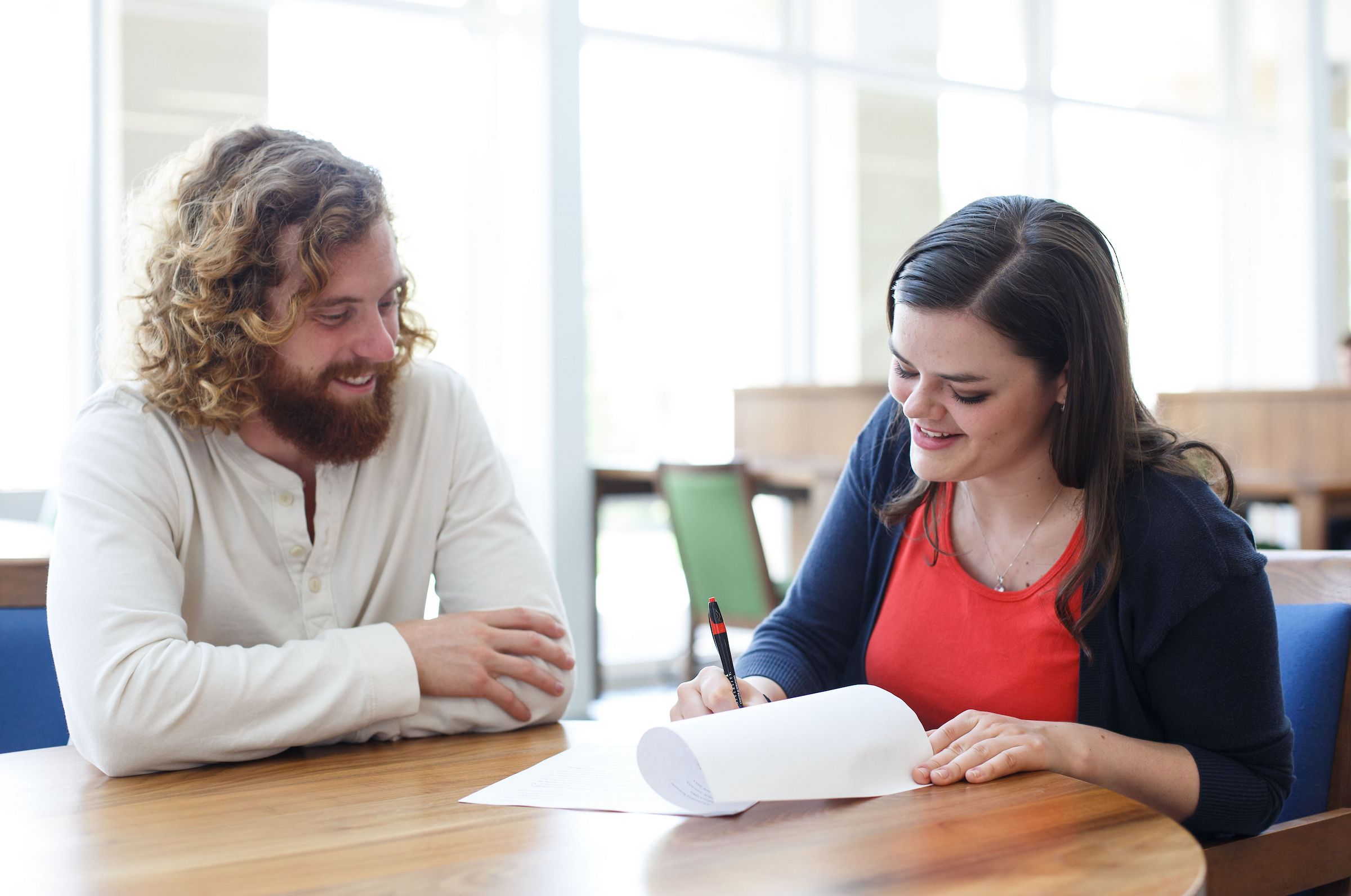 Two students work on a writing assignment