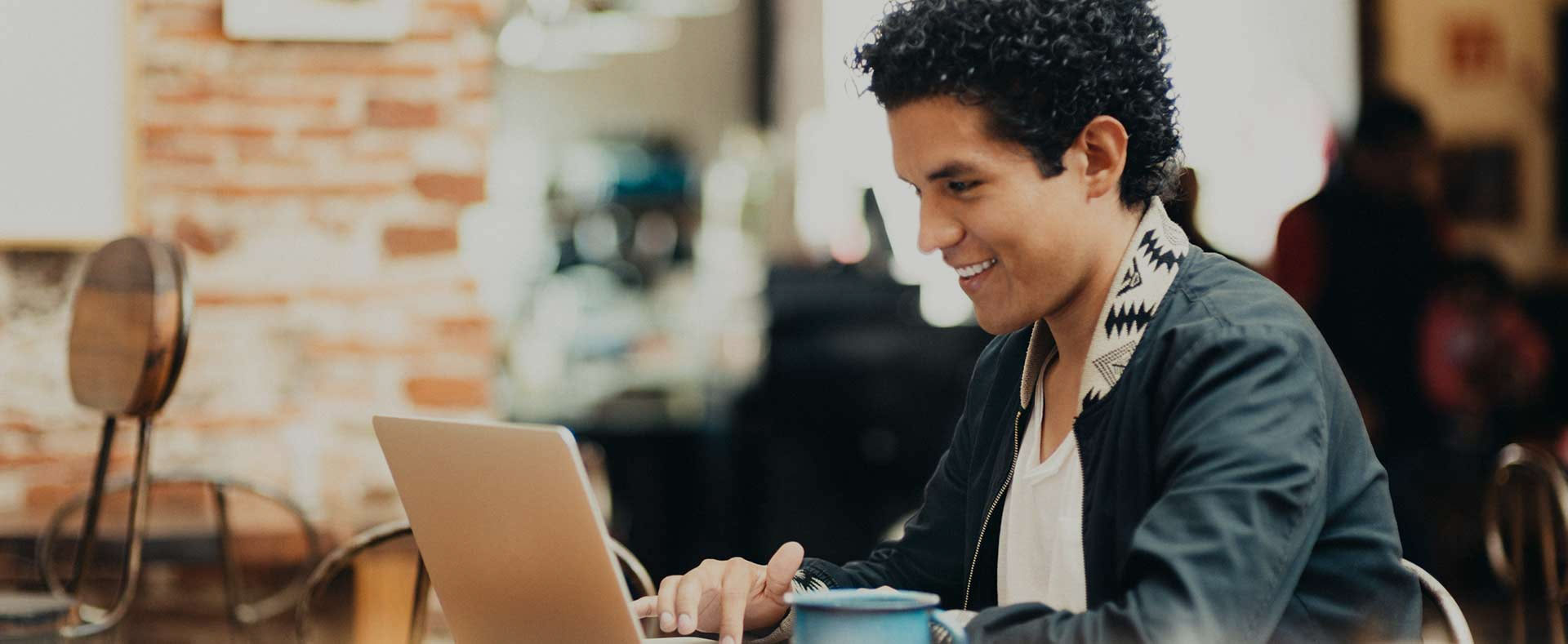 Smiling student working on his computer